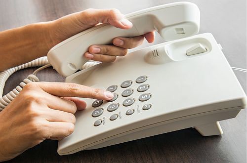 Dialing the phone to book an online psychological therapy